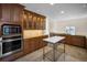 Well-lit kitchen with updated stainless-steel appliances and custom wood cabinets at 962 Marco Ne Dr, St Petersburg, FL 33702