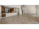 Open living area showcasing staircase, kitchen bar, and tile flooring at 962 Marco Ne Dr, St Petersburg, FL 33702