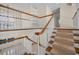 Carpeted staircase with white railing and wood banister leading to the second floor at 962 Marco Ne Dr, St Petersburg, FL 33702