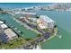 Aerial view of the waterfront condominium complex with marina, boat slips, and swimming pool at 1 Key Capri # 211W, Treasure Island, FL 33706