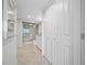 Hallway leading to modern bath with glass enclosed shower and lots of storage at 1 Key Capri # 211W, Treasure Island, FL 33706