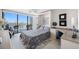 Comfortable bedroom features a murphy bed and balcony access with beautiful water views at 1 Key Capri # 211W, Treasure Island, FL 33706
