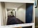Bright hallway with dark tile flooring, leading to apartment doors with a plant at the end of the hall at 1 Key Capri # 211W, Treasure Island, FL 33706