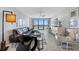 Modern living room featuring a waterfront view, comfortable seating, and stylish decor at 1 Key Capri # 211W, Treasure Island, FL 33706