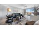 Bright living room featuring a waterfront view, comfortable seating, and modern decor at 1 Key Capri # 211W, Treasure Island, FL 33706