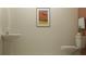 Functional half-bathroom with pedestal sink, toilet, and coordinating modern artwork at 10870 Rustic Eve Ct, Land O Lakes, FL 34638
