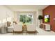 Bright living room featuring neutral-toned furniture, large windows, and a modern entertainment center at 10870 Rustic Eve Ct, Land O Lakes, FL 34638