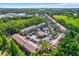 Birds-eye view of a community with well-maintained landscaping, parking, and a central pool area at 11041 Black Swan Ct, Seffner, FL 33584