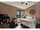 Bedroom with fan, window, decor, and desk area at 11041 Black Swan Ct, Seffner, FL 33584
