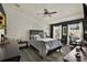 Bedroom with dark accent wall, fan, window with curtains, and desk area at 11041 Black Swan Ct, Seffner, FL 33584