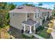 Exterior view of a two-story townhouse with neutral siding and inviting front porch at 11041 Black Swan Ct, Seffner, FL 33584