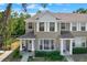 Two-story townhouse exterior with welcoming front porch and manicured landscaping at 11041 Black Swan Ct, Seffner, FL 33584