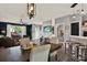 Open-concept living space with hardwood floors, and a bar top leading to the kitchen at 11041 Black Swan Ct, Seffner, FL 33584