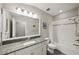Bathroom with granite countertops, white vanity, and shower-tub combination for functionality at 11548 Crowned Sparrow Ln, Tampa, FL 33626