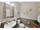 Charming half bathroom with decorative mirror and elegant fixtures at 11548 Crowned Sparrow Ln, Tampa, FL 33626