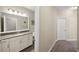 Bathroom with granite countertops, white vanity and cabinet, and tile flooring for an updated look at 11548 Crowned Sparrow Ln, Tampa, FL 33626