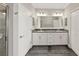 Elegant bathroom with a double-sink vanity, granite countertop, and walk-in shower for everyday comfort at 11548 Crowned Sparrow Ln, Tampa, FL 33626