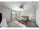 Bright bedroom features a ceiling fan, large window, and neutral decor at 11548 Crowned Sparrow Ln, Tampa, FL 33626
