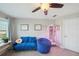 Bedroom features a comfortable sofa and beanbag with natural light and room for plants at 11548 Crowned Sparrow Ln, Tampa, FL 33626
