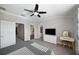This bedroom features a ceiling fan, carpet flooring, walk-in closet, and a dressing table at 11548 Crowned Sparrow Ln, Tampa, FL 33626