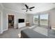 Bright bedroom features a ceiling fan, two windows, and a walk-in closet for ample storage at 11548 Crowned Sparrow Ln, Tampa, FL 33626
