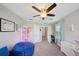 Well-lit bedroom features neutral walls, comfortable furniture, and a ceiling fan at 11548 Crowned Sparrow Ln, Tampa, FL 33626