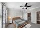 Bedroom with ceiling fan, carpet flooring, and natural light from the window provides comfort at 11548 Crowned Sparrow Ln, Tampa, FL 33626