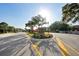 West Lake community entrance featuring brick signage, mature landscaping, and a paved roundabout at 11548 Crowned Sparrow Ln, Tampa, FL 33626