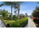 Beautifully landscaped community grounds with hedges, colorful foliage, trees, and sidewalks at 11548 Crowned Sparrow Ln, Tampa, FL 33626
