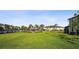 Expansive community lawn leads to a cabana, pool, and a community pond at 11548 Crowned Sparrow Ln, Tampa, FL 33626