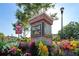 West Lake brick community sign surrounded by colorful flowers, with blue sky and greenery in the background at 11548 Crowned Sparrow Ln, Tampa, FL 33626