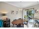 Bright dining area featuring an oval wooden table and modern chandelier over the table at 11548 Crowned Sparrow Ln, Tampa, FL 33626