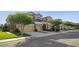 Exterior view of three-story townhomes with driveways, garages, and manicured landscaping at 11548 Crowned Sparrow Ln, Tampa, FL 33626