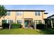Exterior rear view of the home featuring a screened patio and well-maintained yard at 11548 Crowned Sparrow Ln, Tampa, FL 33626