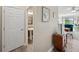 Inviting hallway leading to a well-appointed powder room and a glimpse of the living area at 11548 Crowned Sparrow Ln, Tampa, FL 33626