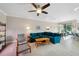 Comfortable living room boasting a modern ceiling fan and stylish furniture at 11548 Crowned Sparrow Ln, Tampa, FL 33626