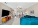 Comfortable living room featuring a plush blue sofa and modern entertainment center at 11548 Crowned Sparrow Ln, Tampa, FL 33626