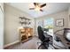 Home office with natural light, desk space, shelving, and carpet flooring for comfort at 11548 Crowned Sparrow Ln, Tampa, FL 33626
