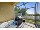 Relaxing screened patio featuring an outdoor grill and comfortable seating area at 11548 Crowned Sparrow Ln, Tampa, FL 33626