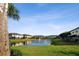 Waterfront townhomes feature a serene pond view, well-manicured lawns, and green landscaping at 11548 Crowned Sparrow Ln, Tampa, FL 33626