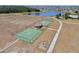 Aerial view of basketball courts, a pond and playground within the community at 11625 Tetrafin Dr, Riverview, FL 33579