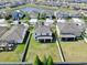 Aerial view of the home, backyard, and community pond, showing solar panels on the roof at 11625 Tetrafin Dr, Riverview, FL 33579