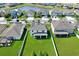 Aerial view of home featuring a well-manicured lawn, screened-in porch, and neighborhood pond at 11625 Tetrafin Dr, Riverview, FL 33579