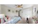 Cozy bedroom featuring natural light, carpeted floors, and a ceiling fan at 11625 Tetrafin Dr, Riverview, FL 33579
