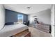Comfortable bedroom with natural light, carpet, and a decorative blue accent wall at 11625 Tetrafin Dr, Riverview, FL 33579