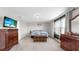 Inviting bedroom with carpeting, a comfortable bed, and dresser with mirror and view of adjoining room at 11625 Tetrafin Dr, Riverview, FL 33579