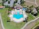 Aerial view of a large community pool area with lounge chairs, and manicured landscaping at 11625 Tetrafin Dr, Riverview, FL 33579