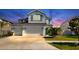 Charming two-story home featuring a three-car garage, landscaped yard, and crisp white exterior at 11625 Tetrafin Dr, Riverview, FL 33579