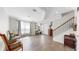Bright foyer features wood-look tile flooring, white trim, and a staircase with decorative wrought iron spindles at 11625 Tetrafin Dr, Riverview, FL 33579