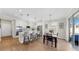 Elegant kitchen with an island, white cabinetry, stainless appliances, and a cozy dining area at 11625 Tetrafin Dr, Riverview, FL 33579